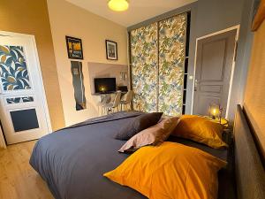a bedroom with a bed with two pillows and a window at Chambres d'hôtes "Le Clos de la Baie" in Paimpol
