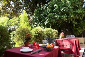 a table with a red table cloth and fruit on it at Hotel Cristallo in Conegliano