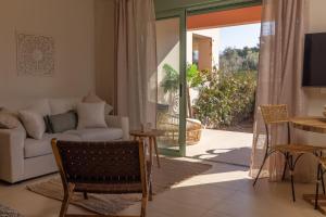 a living room with a couch and a table at Ionian Nest Studio in Pogoniá