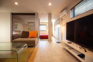 a living room with a large television and a couch at Bito Petrip hotel 美都ペットリップホテル #LP1 in Tuyama