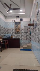 a room with a wall with blue and white tiles at Rk cottage in Rāmeswaram +1 photo