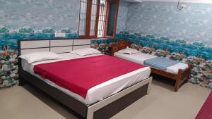 a bedroom with two beds in a room at Rk cottage in Rāmeswaram