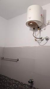 a white light on a wall in a bathroom at Rk cottage in Rāmeswaram