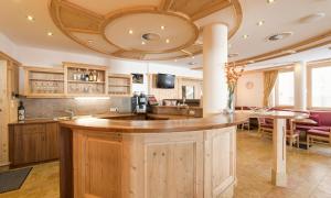a kitchen with a large wooden island in a room at Hotel Abendrot by Alpeffect Hotels in Ischgl