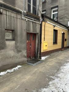 a red door on the side of a building at Apartament w Centrum - Parking in Ostrów Wielkopolski
