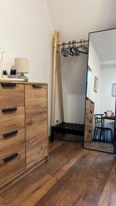 a bedroom with a dresser and a mirror at Apartament w Centrum - Parking in Ostrów Wielkopolski