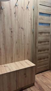 a bathroom with wooden walls and a wooden counter at Apartament w Centrum - Parking in Ostrów Wielkopolski