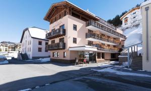 a large apartment building in a parking lot at Hotel Abendrot by Alpeffect Hotels in Ischgl