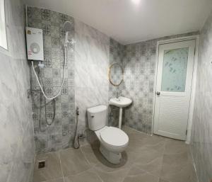 a bathroom with a toilet and a shower and a sink at บ้านมาดาม เขาใหญ่ in Pak Chong +19 photos