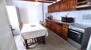 a small kitchen with a table and a stove at La madeleine in Malandry