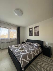a bedroom with a large bed in a room at Apartment OrMarić in Otočac