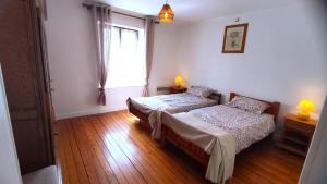 a bedroom with two beds and a window at La madeleine in Malandry