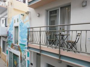 a balcony with a table and chairs on it at Pietra Sole Residences in Ierapetra