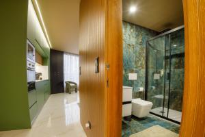 a bathroom with a toilet and a glass shower at Casa de Cristal by Oporto Soul in Porto +286 photos