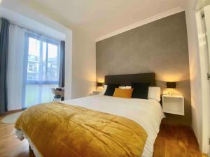 a bedroom with a large bed and a large window at Central Urban Elegance in Barcelona