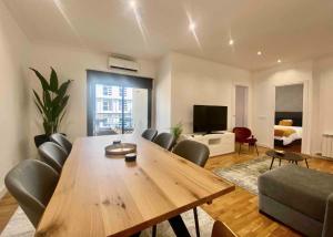 a living room with a large wooden table and chairs at Central Urban Elegance in Barcelona