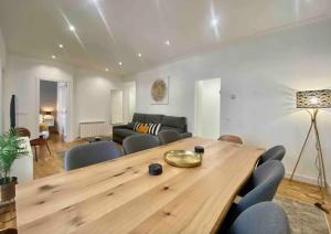 a living room with a wooden table and chairs at Central Urban Elegance in Barcelona