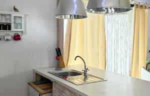 a kitchen counter with a sink and two lights at Stunning Home In Rybical With Wifi in Rybical +9 photos