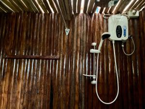 a wooden wall with a shower in a bathroom at Babaland in New Agutaya +34 photos