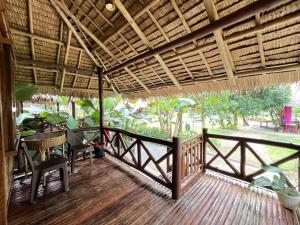 a porch of a house with a table and chairs at Babaland in New Agutaya