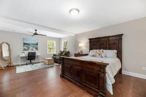 a bedroom with a large bed and a living room at Peaceful Kannapolis Lodge in Kannapolis