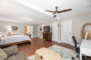 a bedroom with a bed and a flat screen tv at Peaceful Kannapolis Lodge in Kannapolis