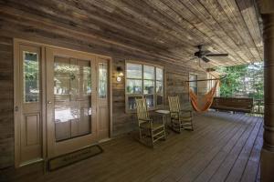 a porch with chairs and a hammock in a cabin at Peaceful Kannapolis Lodge in Kannapolis +31 photos