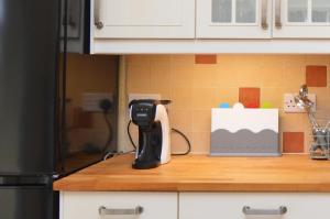 a kitchen counter with a hair dryer on a counter top at Dunmore Argyll House in Dunoon +25 photos