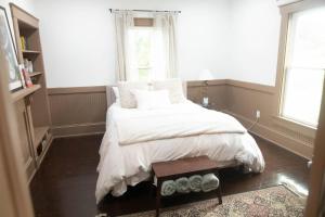 a bedroom with a bed with white blankets and pillows at ASecondU Peaceful Retreat in Salisbury