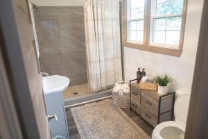 a bathroom with a sink and a toilet and a window at ASecondU Peaceful Retreat in Salisbury