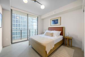 a bedroom with a bed and a large window at Prime Location Studio Steps from Top Attractions in Miami +17 photos