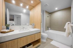 a bathroom with a sink and a tub and a toilet at Prime Location Studio Steps from Top Attractions in Miami