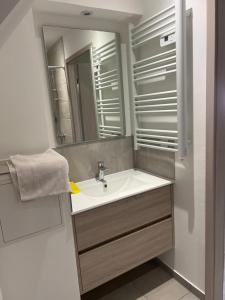 a bathroom with a sink and a mirror at Aux cigogneaux in Guémar +13 photos