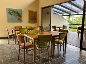 a dining room with wooden tables and chairs at Finca Las Raíces Posada Rural in Zarcero