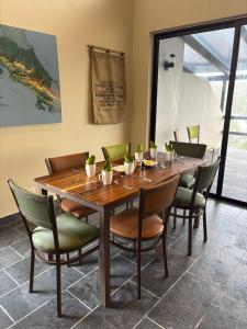 a wooden table and chairs in a room at Finca Las Raíces Posada Rural in Zarcero +39 photos