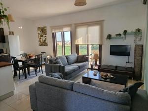 a living room with a couch and a table at corali in Tersephanou