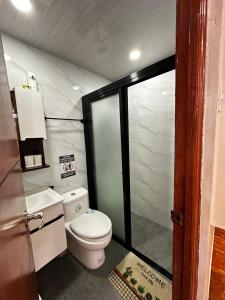 a bathroom with a white toilet in a room at Casa Terrazza Marteja in Malolos