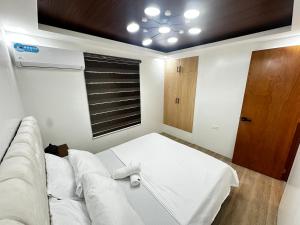a living room with a white couch and a window at Casa Terrazza Marteja in Malolos