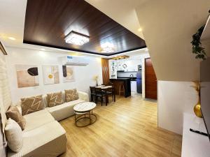 a living room with a couch and a table at Casa Terrazza Marteja in Malolos +7 photos