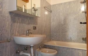 a bathroom with a sink and a toilet and a tub at Accogliente mansarda con vista Dolomiti in Borca di Cadore