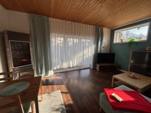 a living room with a large window and a television at Morgensonne in Putbus
