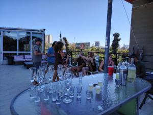a group of people sitting around a table with glasses on it at Guanako Rooftop Hostel in Santiago