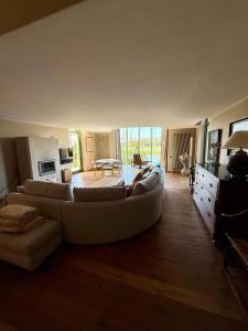 a living room with a couch and a table at Villa Francine in Deinze