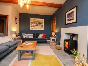 a living room with a couch and a fireplace at Kirk Yett in Skipton