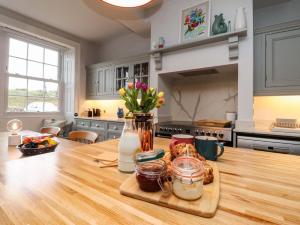 a kitchen with a wooden table with food on it at Kirk Yett in Skipton