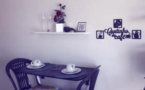 a small table with two cups and plates on it at Suíte panorama histórico in Manaus