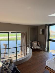 a living room with a view of the water at Villa Francine in Deinze