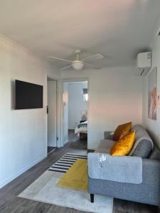 a living room with a couch and a flat screen tv at Convenient Getaway Home in Strathpine in Strathpine