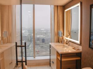 a bathroom with a sink and a large window at Hollywood Casino at Greektown in Detroit +42 photos