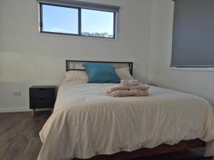 a bedroom with a large bed with a window at Convenient Getaway Home in Strathpine in Strathpine